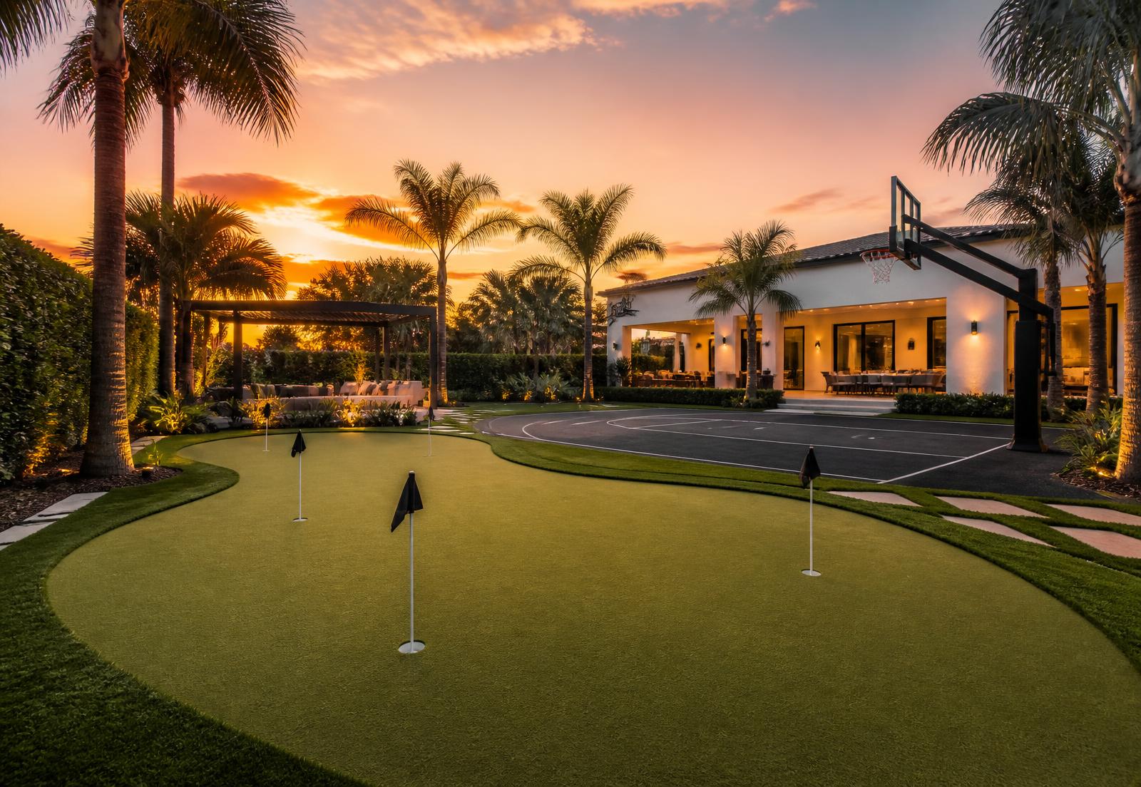 Backyard putting green and private sport court at sunset